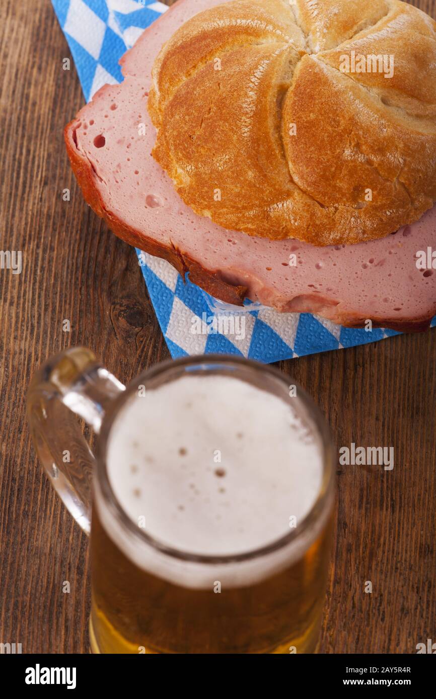 Bavarian Leberkäse in a bread roll with beer Stock Photo