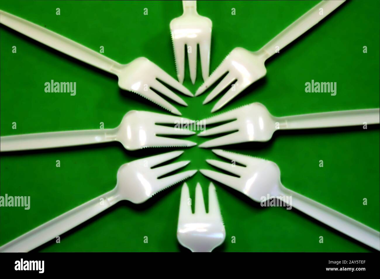 Fork white with plastic snack bar on green bottom. Stock Photo