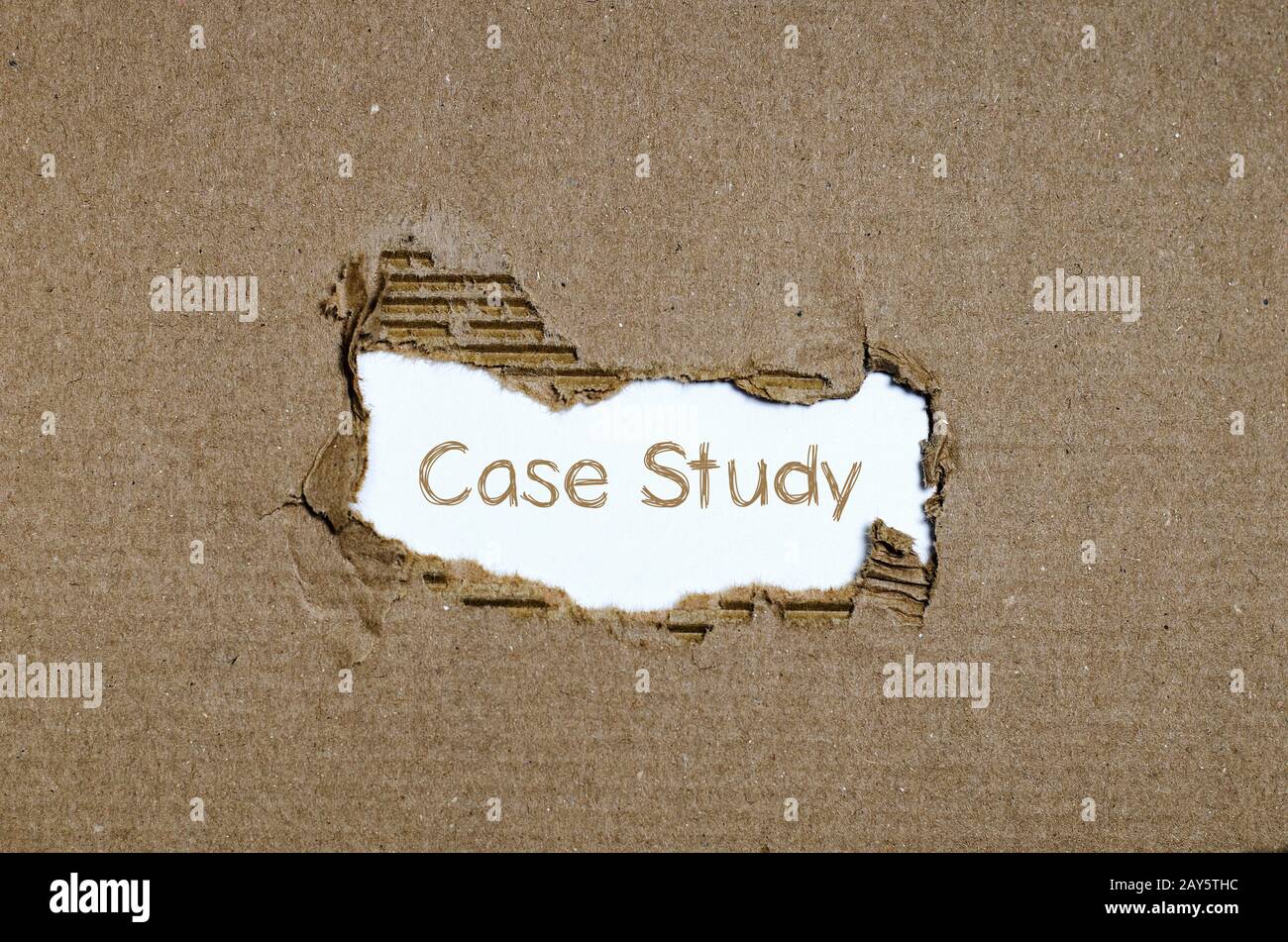 The word case study appearing behind torn paper. Stock Photo