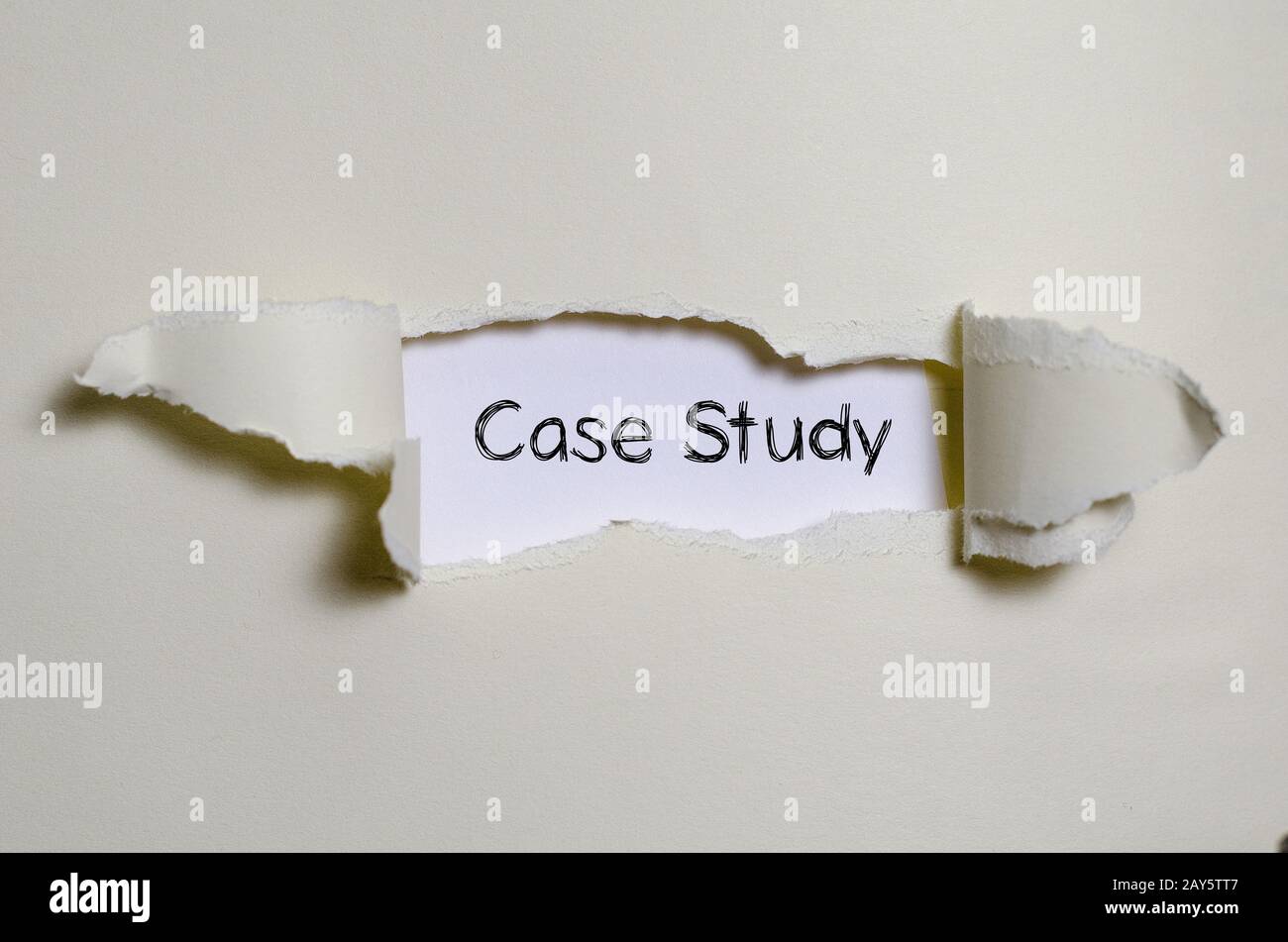The word case study appearing behind torn paper. Stock Photo