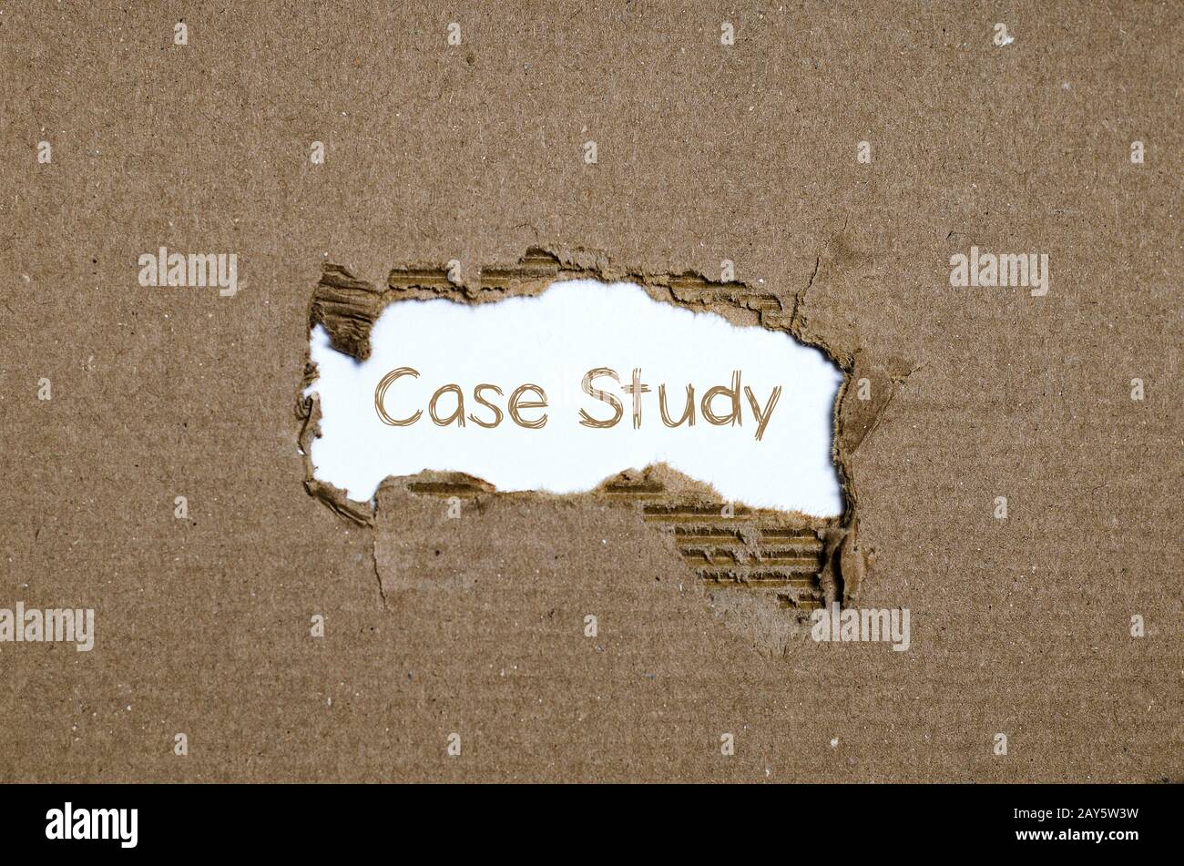 The word case study appearing behind torn paper. Stock Photo