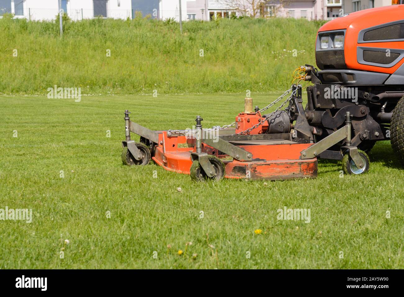 Lawn is cut with a ride-on mower - Lawn tractor Stock Photo