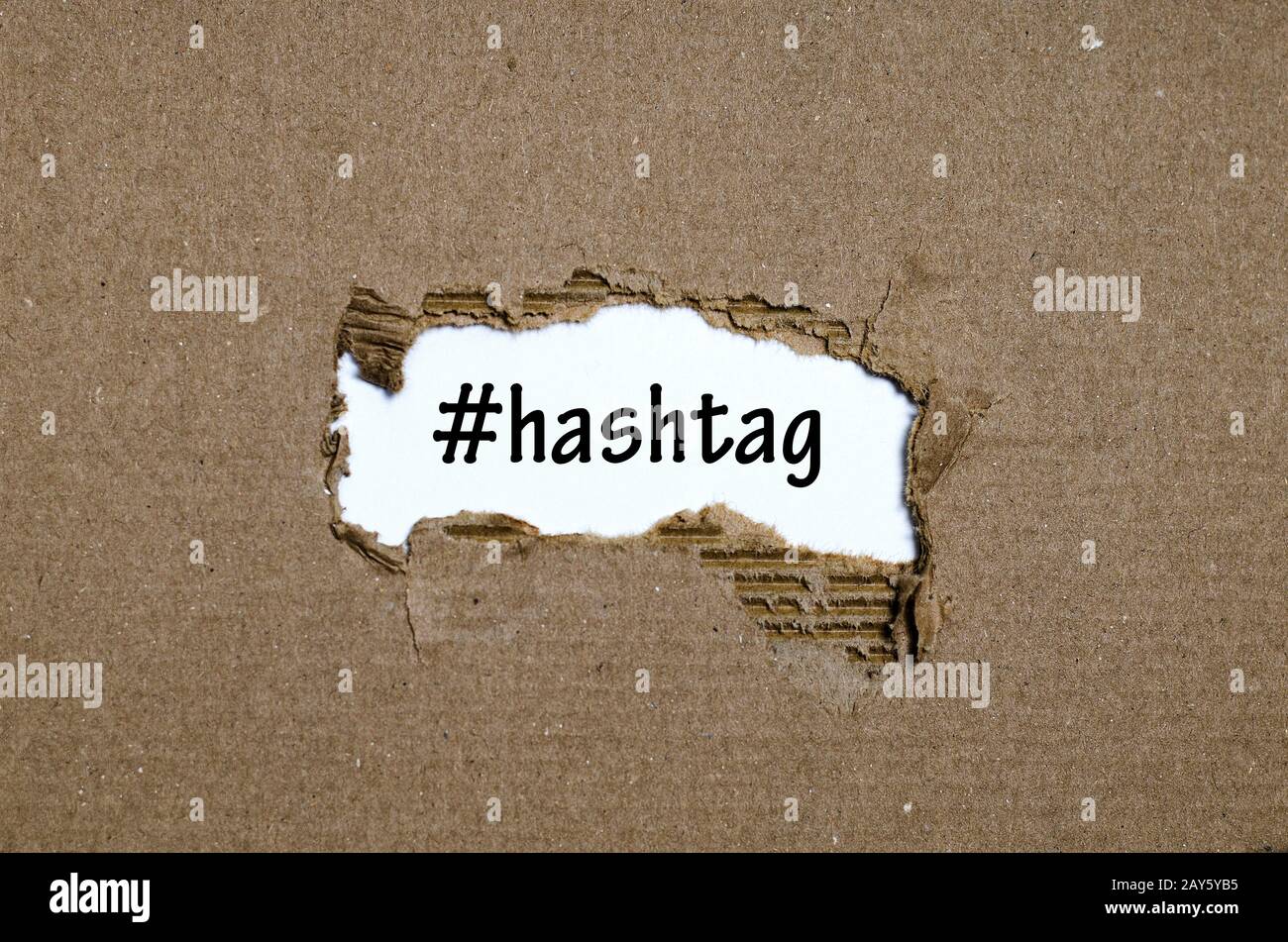 Hashtag Paper The word hashtag appearing behind torn paper Stock Photo - Alamy
