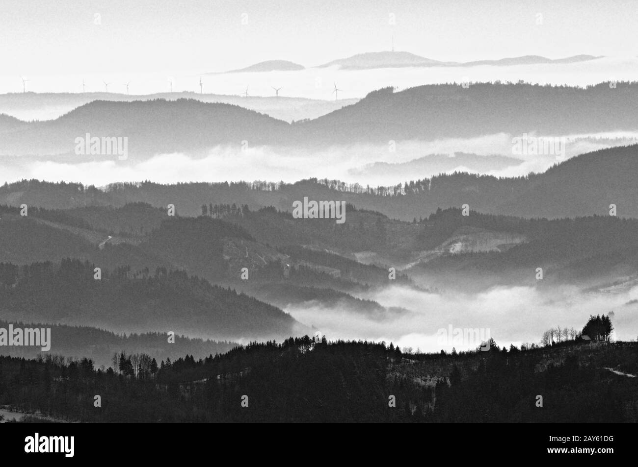 View of the northern central Black Forest towards Feldberg in foggy winter black and white Stock Photo