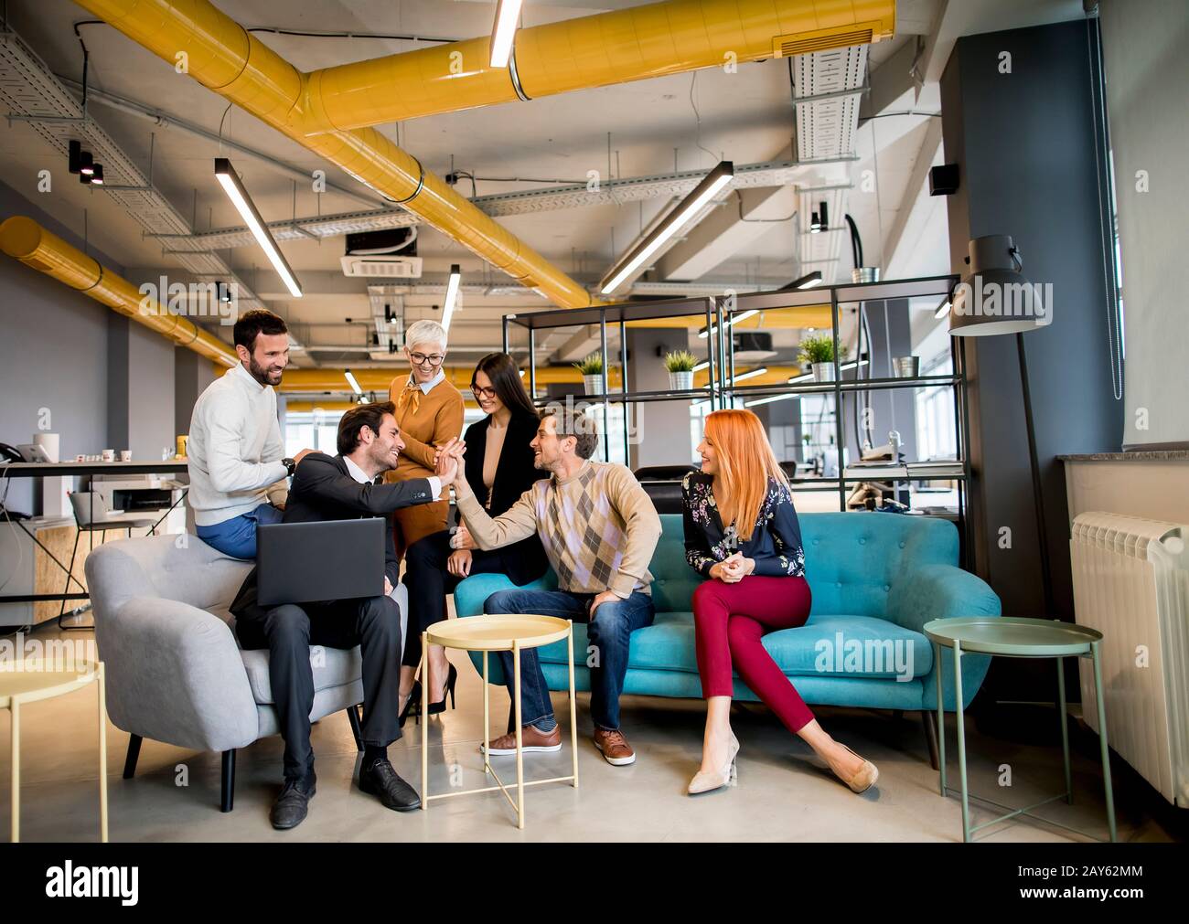 Smiling diverse businesspeople talking together in an office Stock Photo