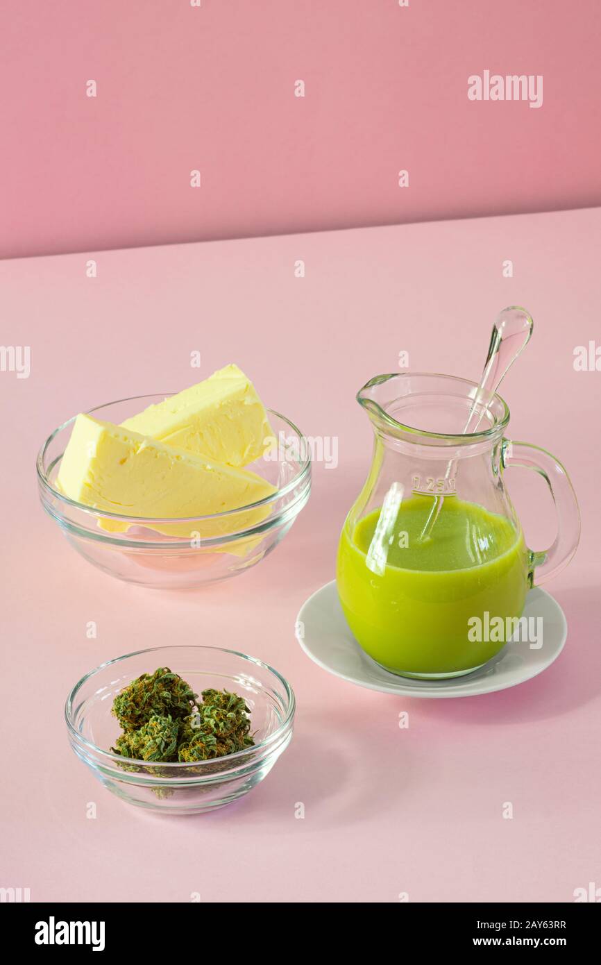 Making Cannabutter for Baking Edibles with Butter and Cannabis or Hemp on Pink Background Stock Photo