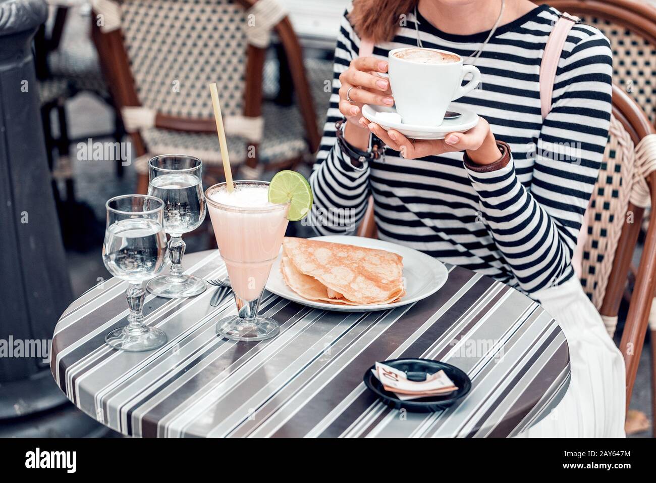 Asian girl left a generous tip after Breakfast in a street cafe Stock Photo
