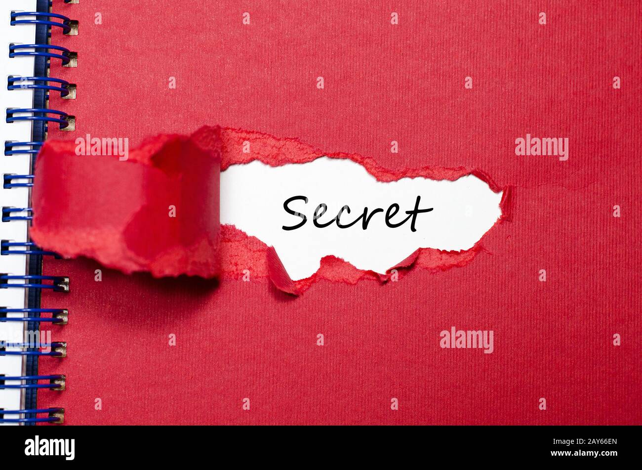 The word secret appearing behind torn paper Stock Photo