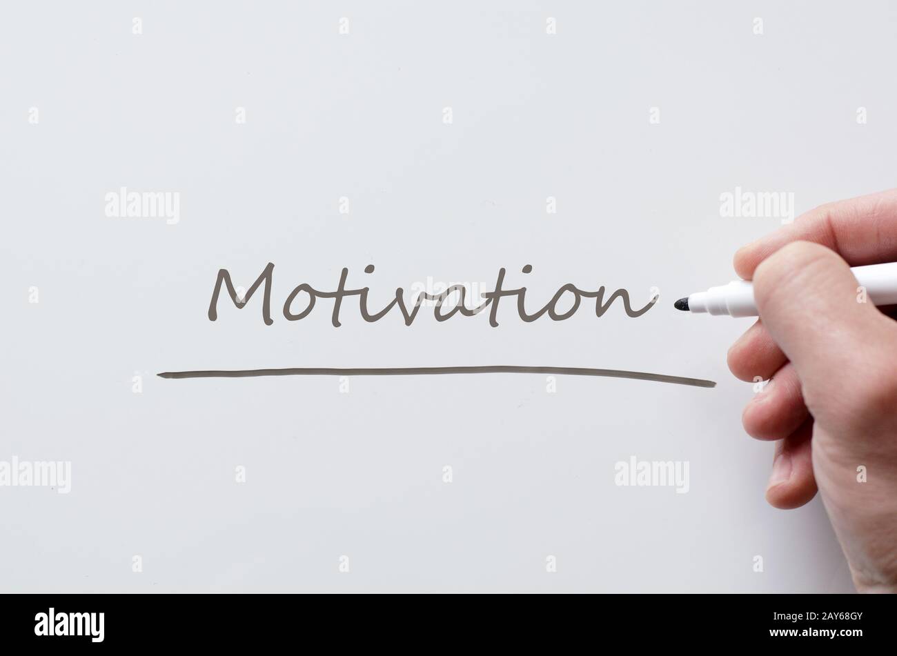 Motivation written on whiteboard Stock Photo