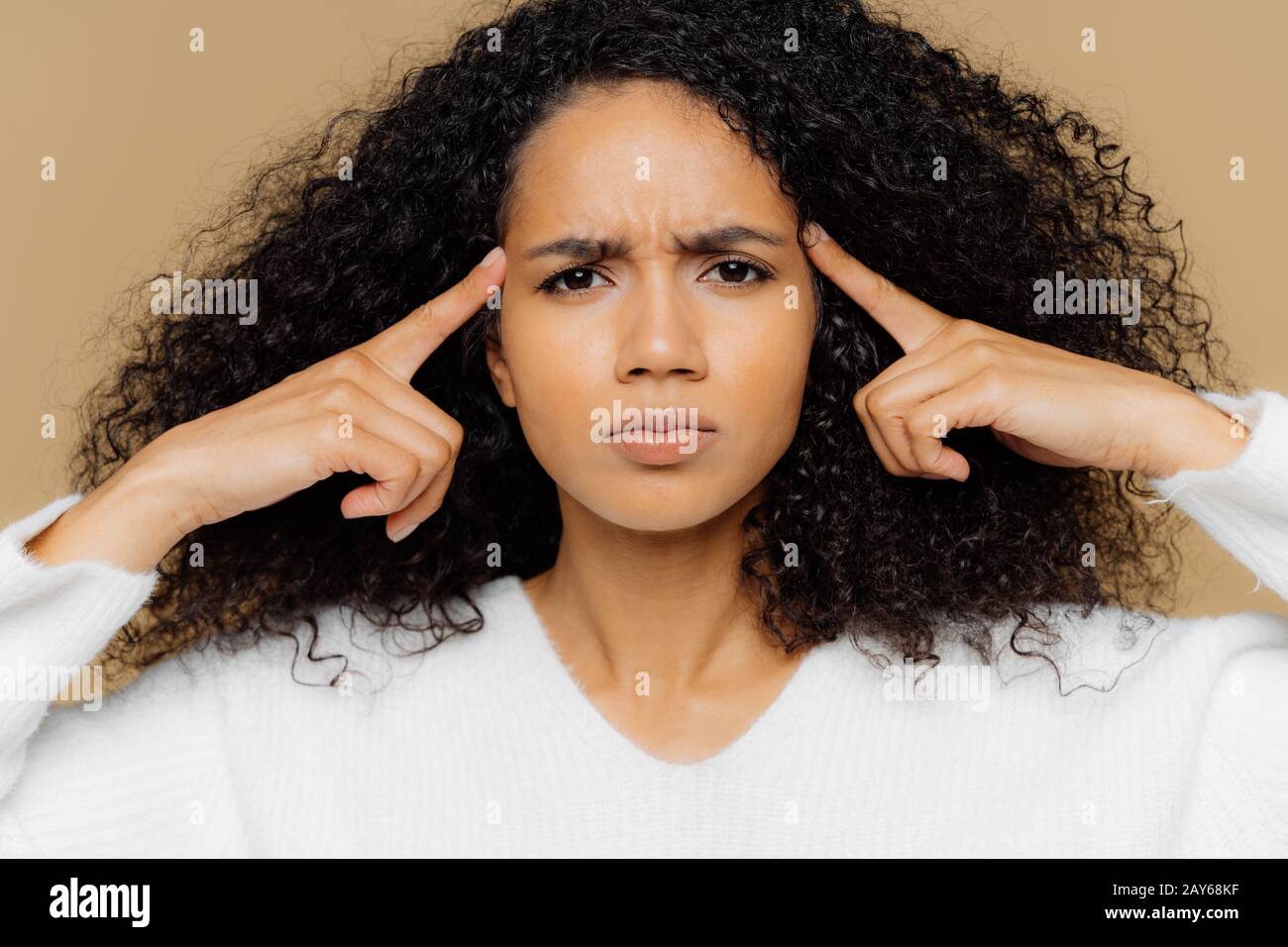 Headshot of stressful Afro American woman keeps index fingers on ...