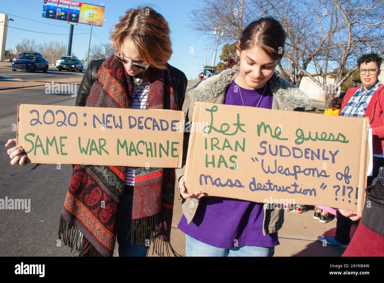 01-04-2020 Tulsa USA - Mother and Daughter with protest signs - one says Let me guess - Iran suddenly has weapons of mass destruction Stock Photo