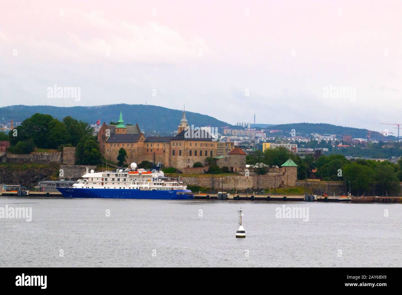 Akershus Festning ,Cruise Terminal and Oslo skyline seen  tfrom the fjord.Akershus Fortress or Castle is a medieval castle in the Norwegian capital Stock Photo