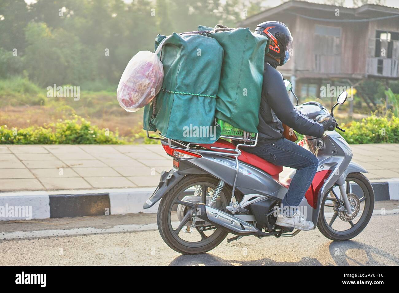 An overloaded motorcycle in Thailand. Stock Photo