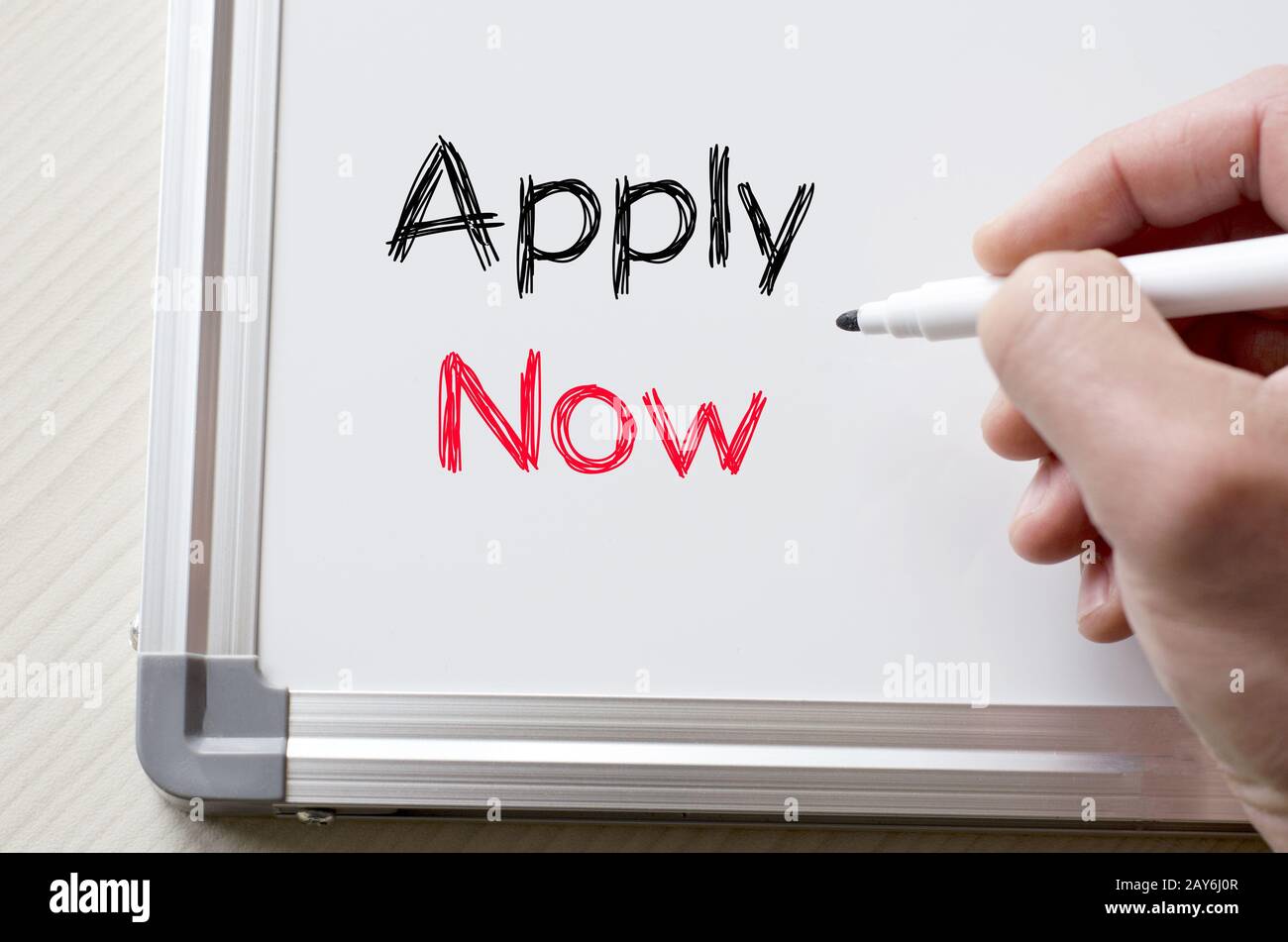 Apply now written on whiteboard Stock Photo