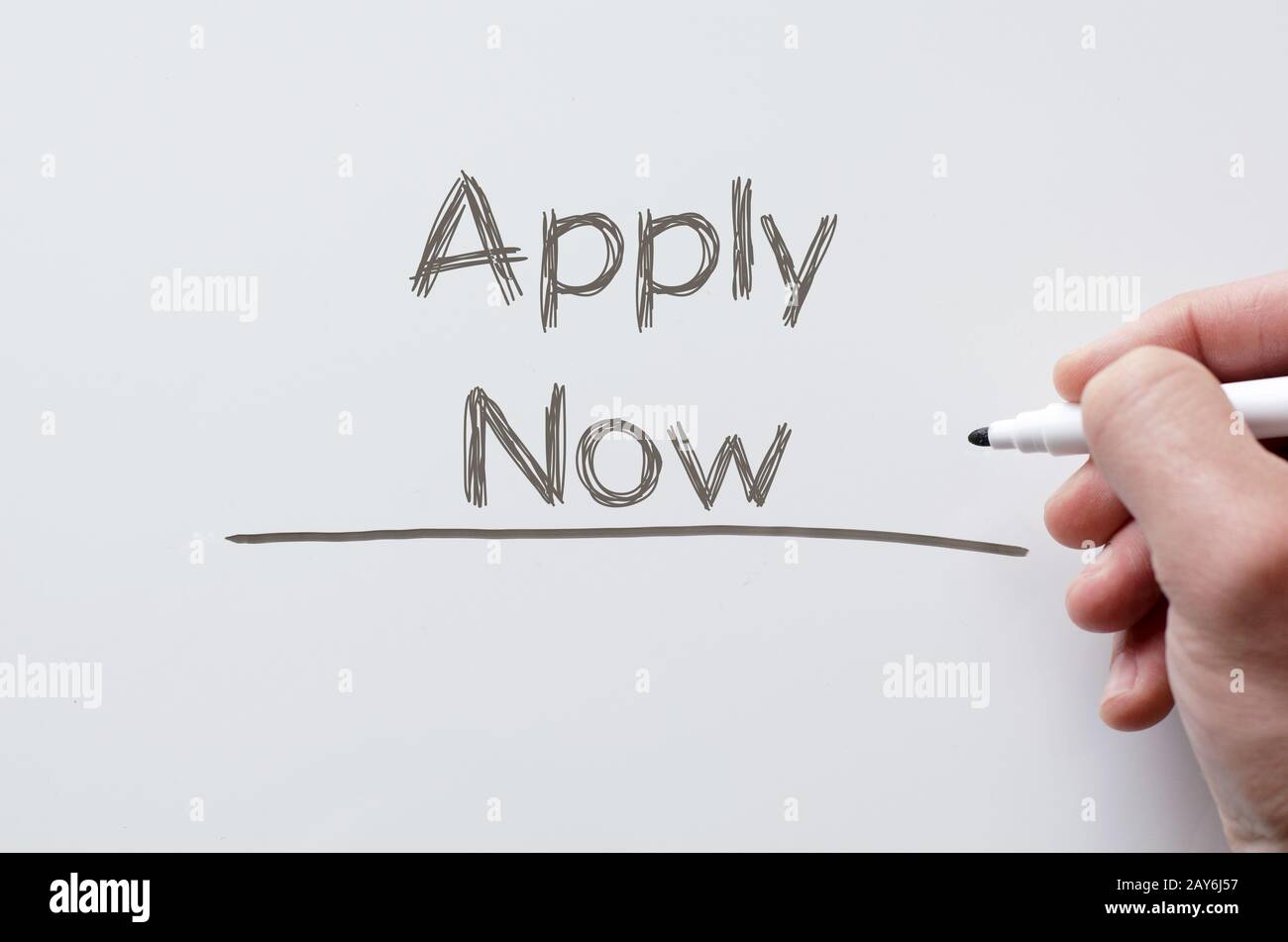 Apply now written on whiteboard Stock Photo