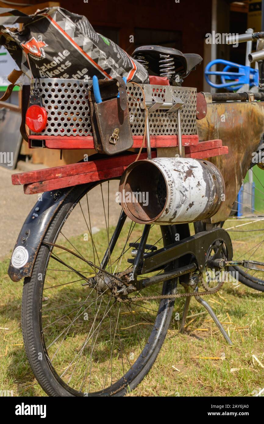 original second-hand bike fully loaded - old bike with recycling articles Stock Photo