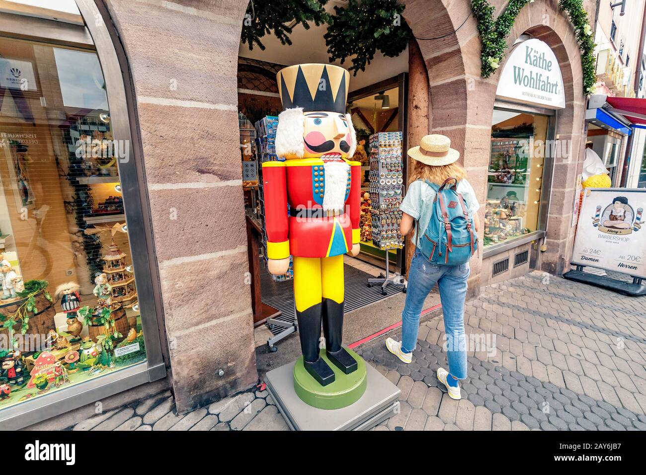 05 August 2019, Nuremberg, Germany Tourist enters souvenir shop with
