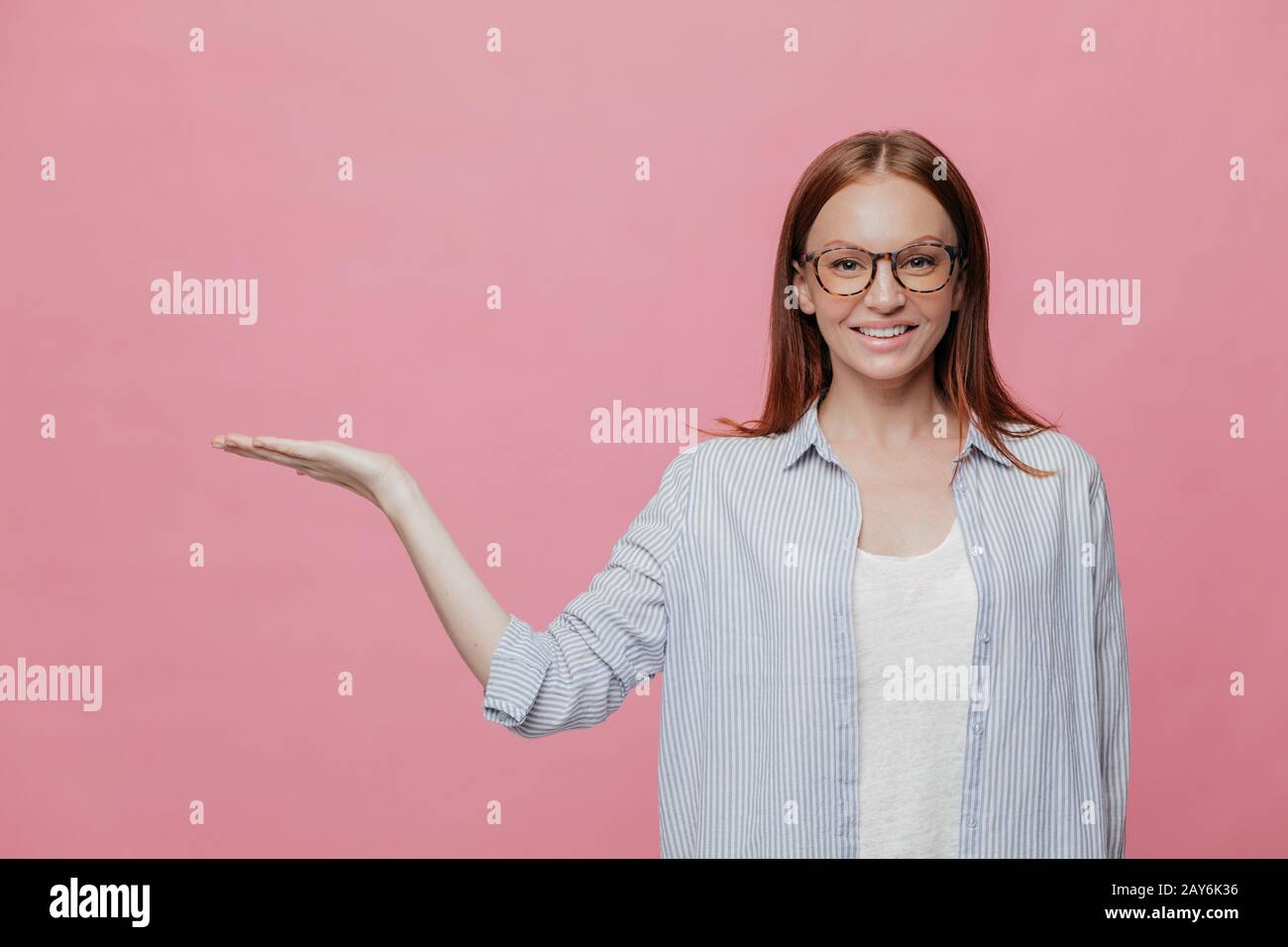 Woman raises arm holds hi-res stock photography and images - Alamy