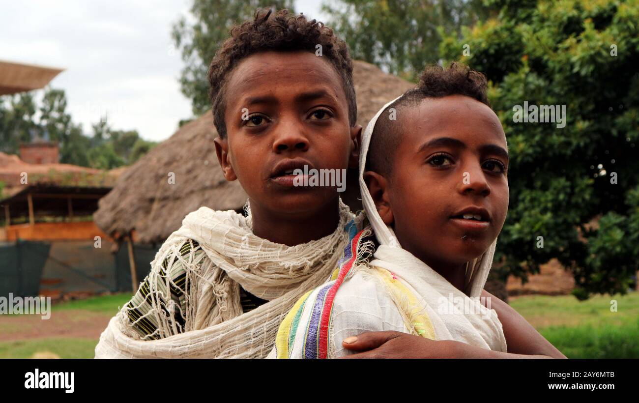 Two young Ethiopian boys in traditional white shoals in Lalibela, Ethiopia Stock Photo