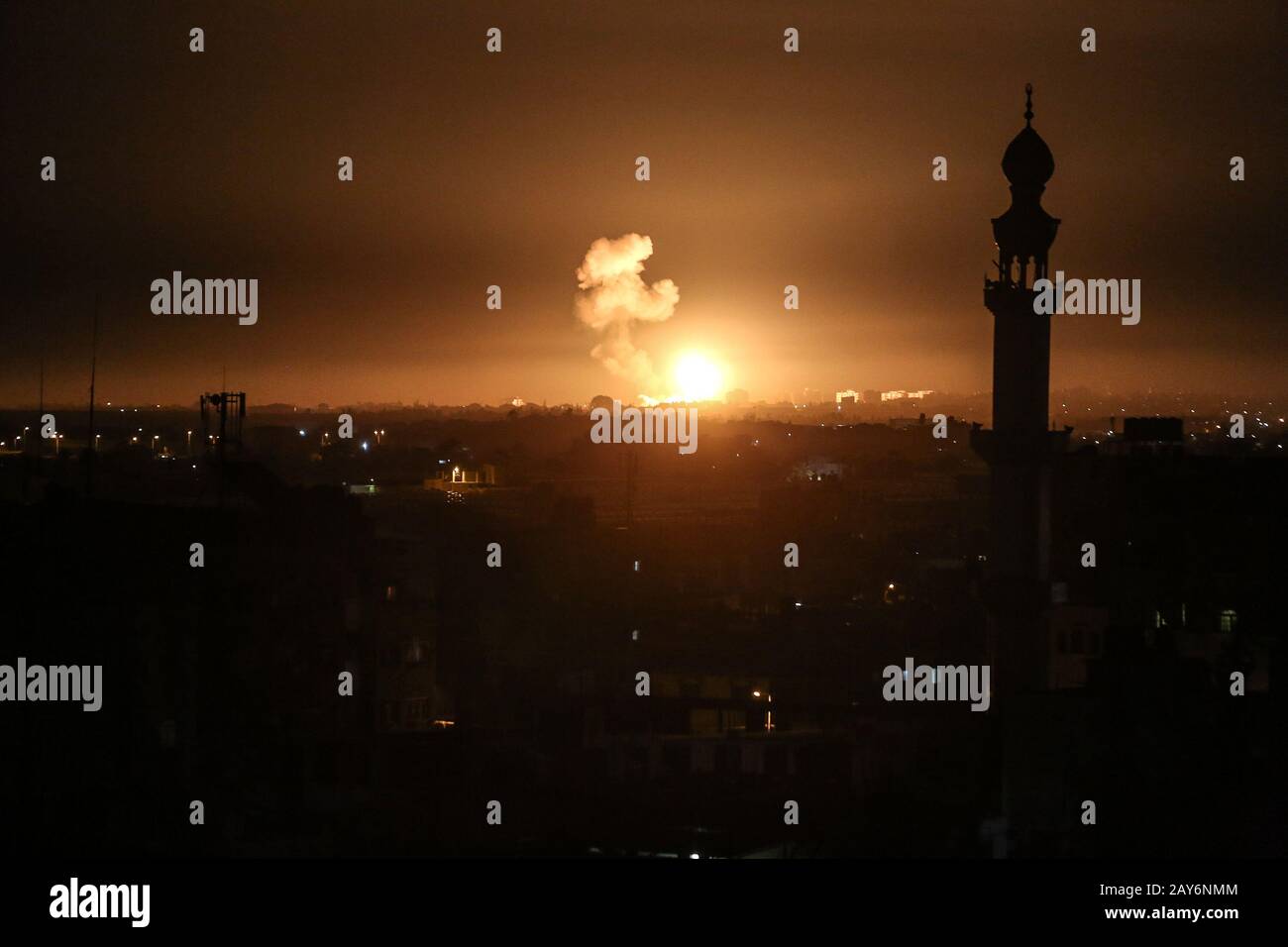 A ball of fire and smoke rises above buildings during Israeli airstrikes targeting positions of Qassam, the Hamas, in the Gaza Strip, on Feb 05, 2020. Stock Photo