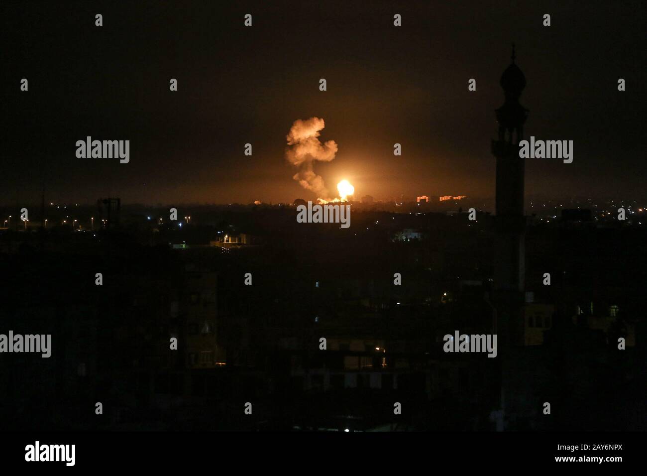 A ball of fire and smoke rises above buildings during Israeli airstrikes targeting positions of Qassam, the Hamas, in the Gaza Strip, on Feb 05, 2020. Stock Photo