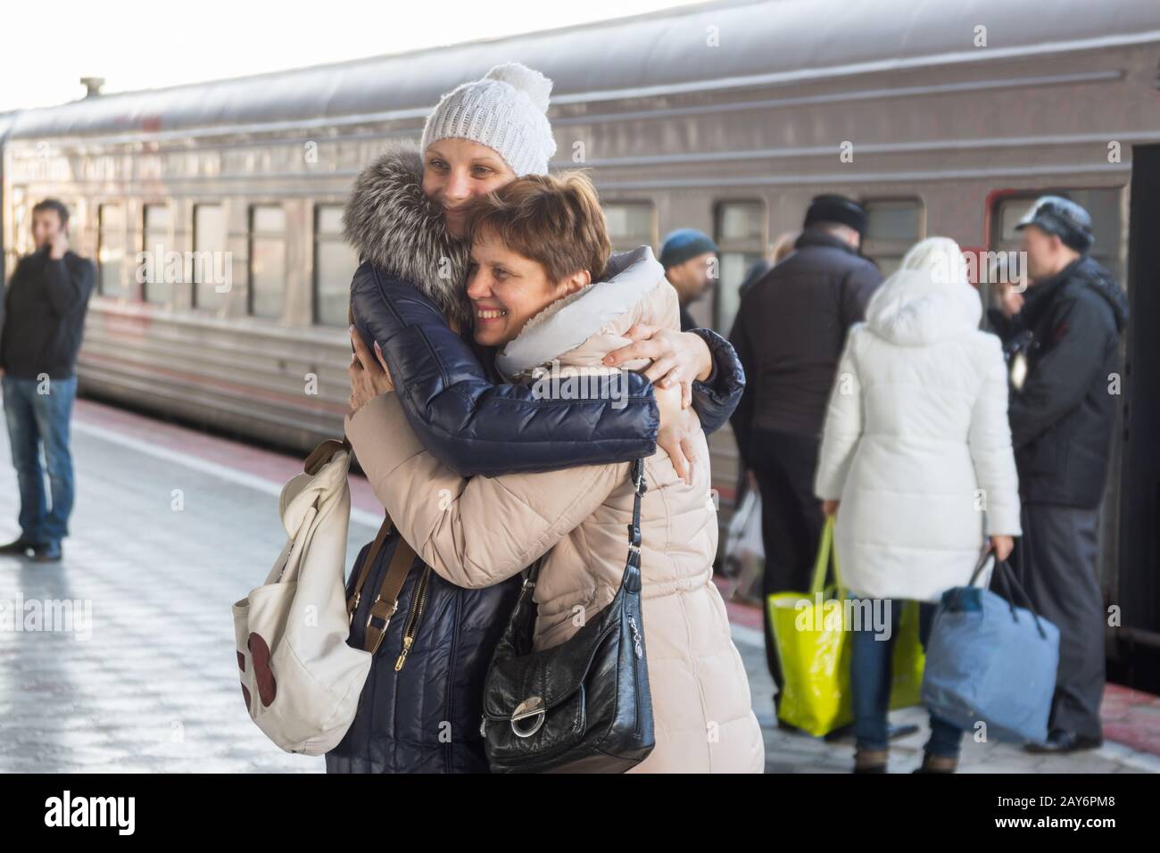 Adult daughter met my mother at the train at the station Stock Photo