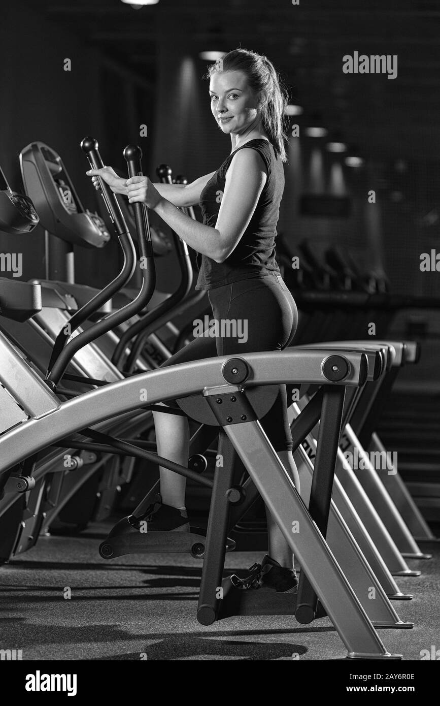 Young woman at the gym exercising. Run on machine. Stock Photo