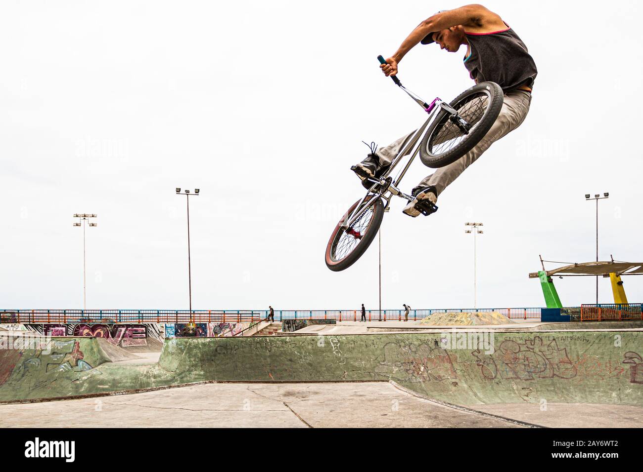 Young man jumping with a BMX bicycle at Skatepark, in Playa Brava. Iquique, Tarapaca Region, Chile. Stock Photo
