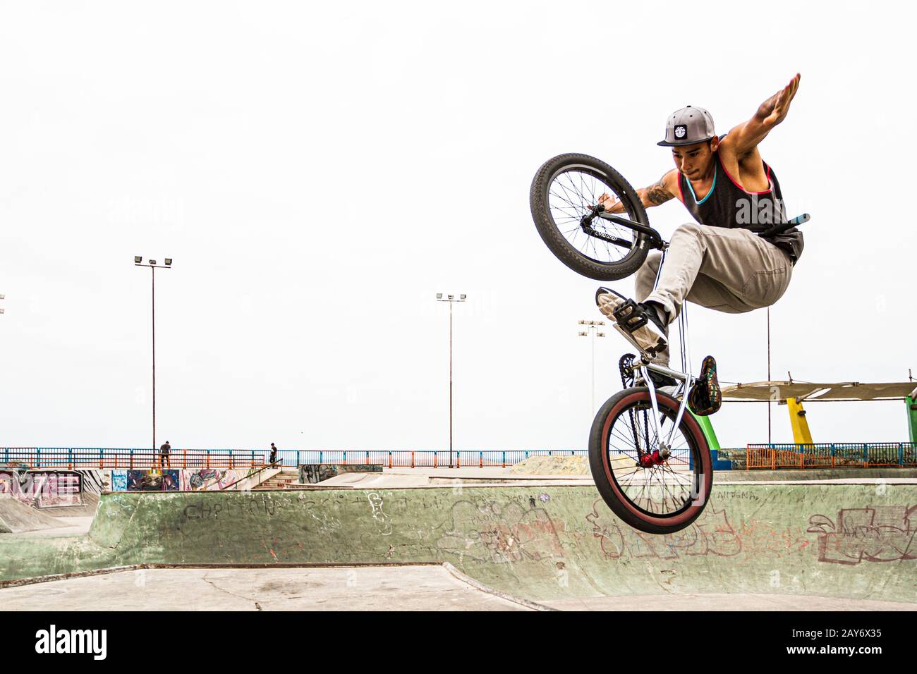 Young man jumping with a BMX bicycle at Skatepark, in Playa Brava. Iquique, Tarapaca Region, Chile. Stock Photo