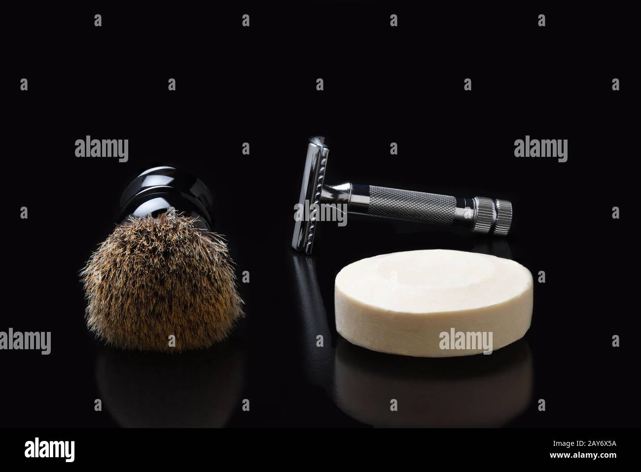 Shaving still life. A razor shaving brush and bar of soap on black. Stock Photo