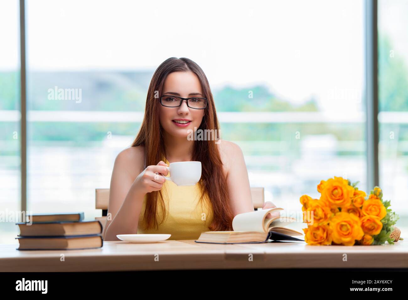 Young student drinking coffee while sudying Stock Photo Alamy