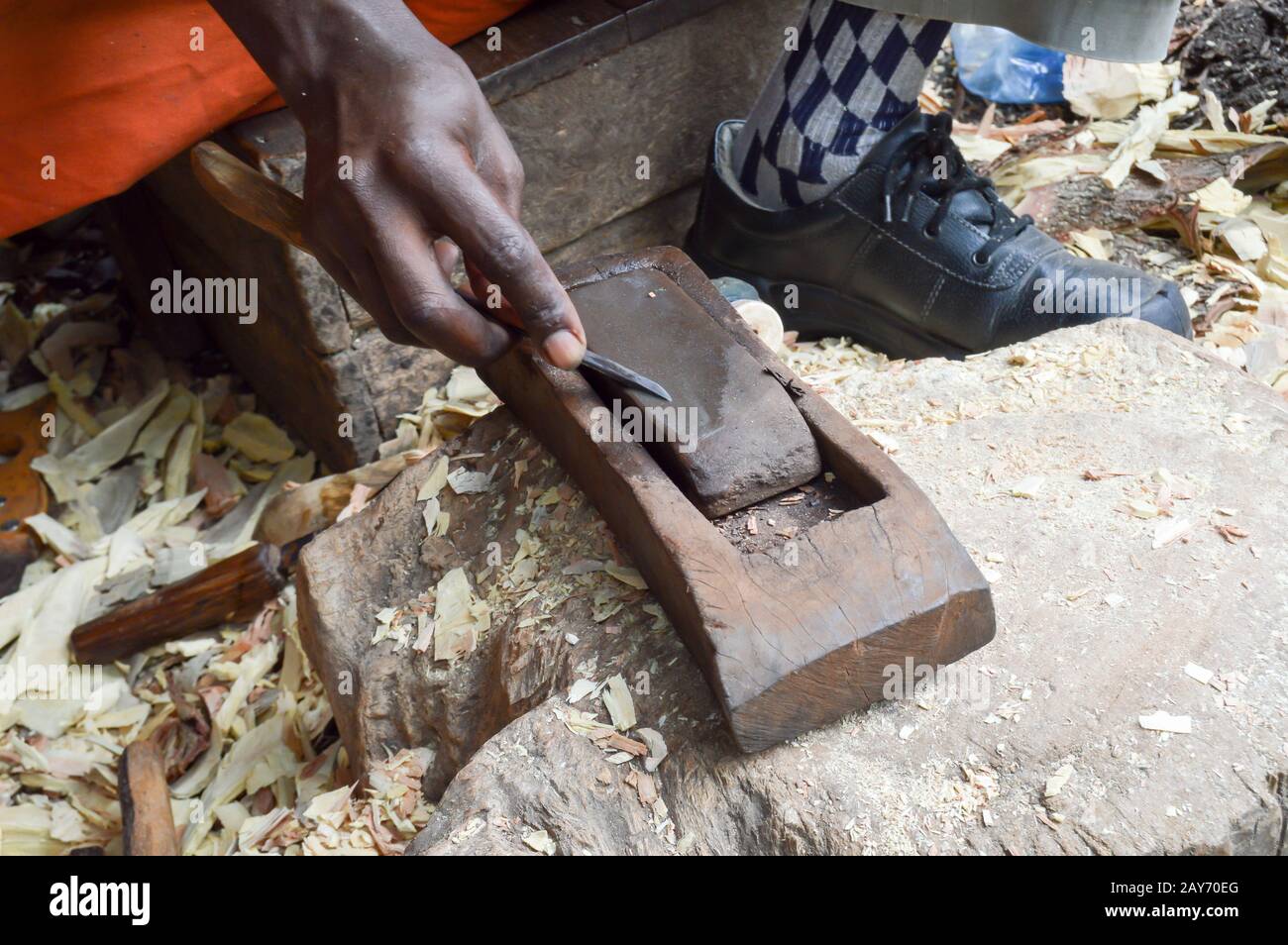 Kenyan sculptor sharpening a chisel Stock Photo Alamy