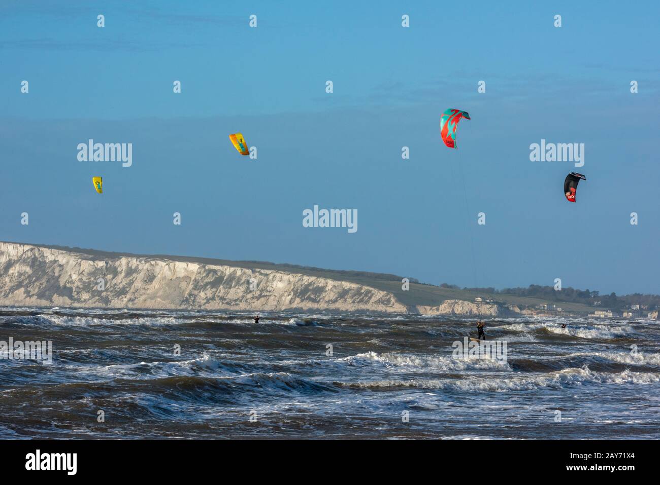 kite surfing surfers at freshwater bay and compton bay on the isle of wight with a clear blue