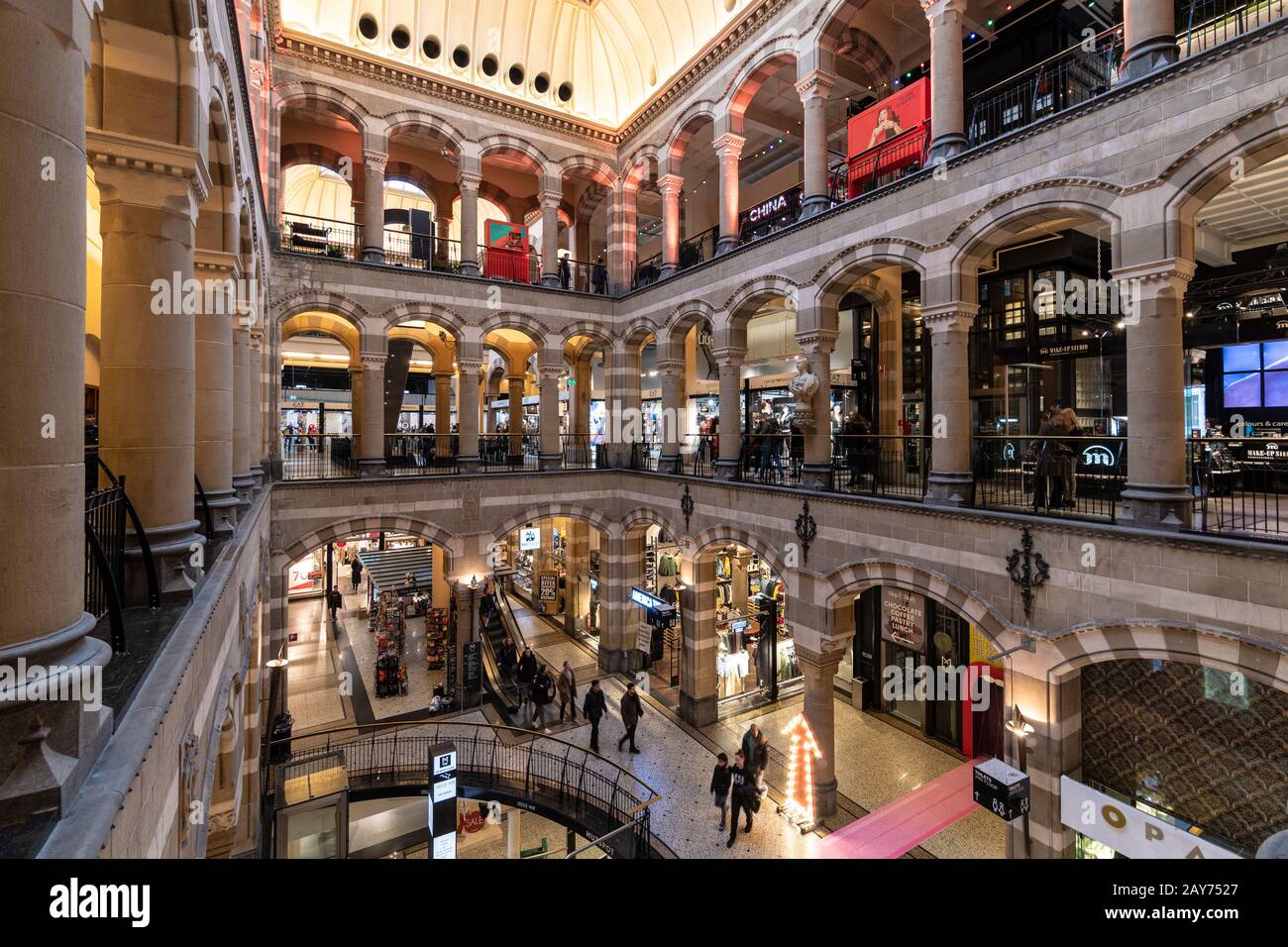 Amsterdam, Netherlands - January 30 2020: People strall inside the luxury Magna Plaza shopping mall in Amsterdam. The building dates from the 19th cen Stock Photo