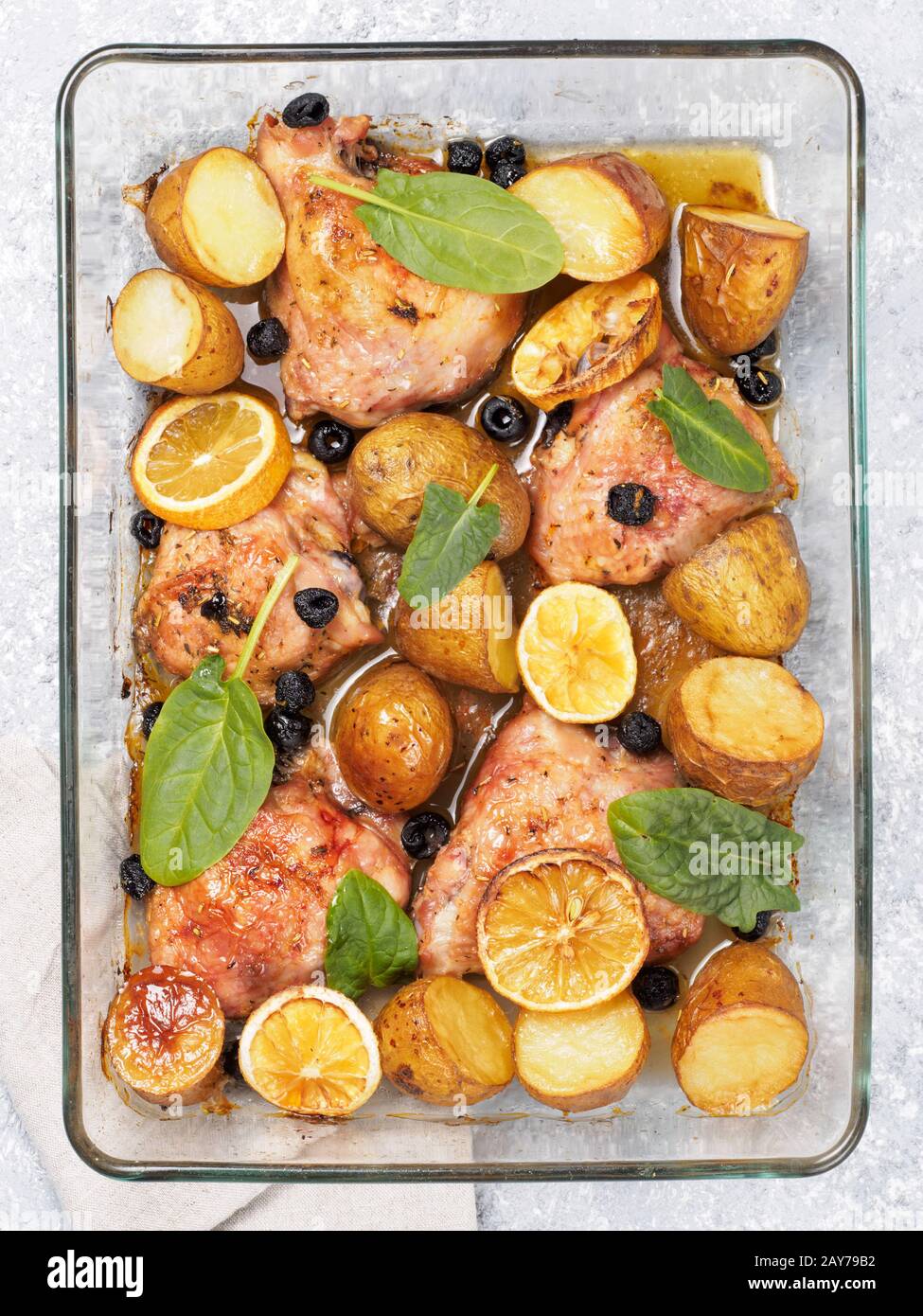 Baked chicken leg quarter with potatoes and lemon Stock Photo Alamy