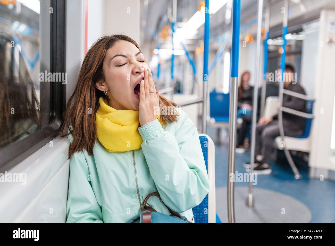 The girl suffering from insomnia sleeps or taking a nap in the subway while tired goes home from work Stock Photo