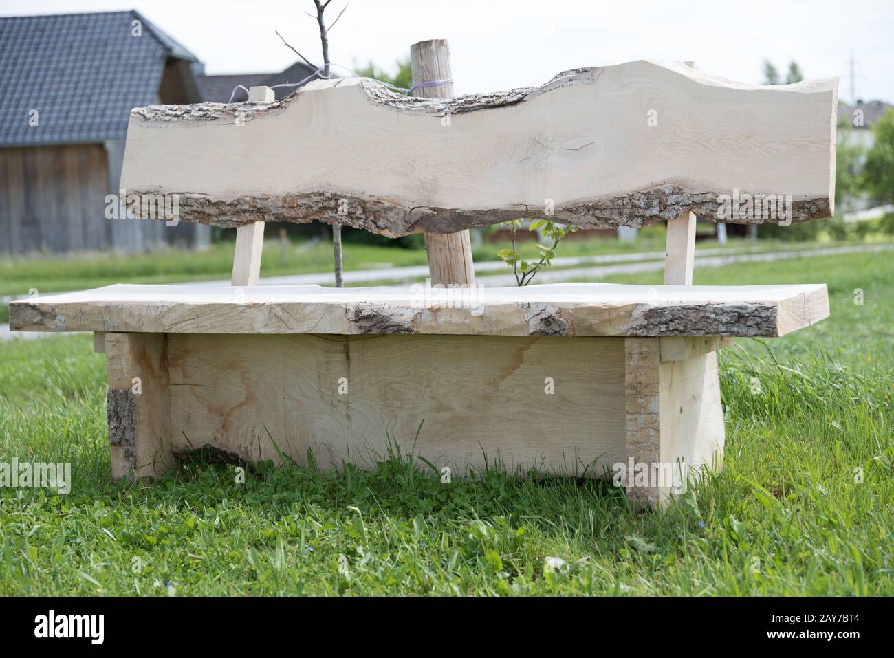Solid wood garden bench invites you to take a break Stock Photo