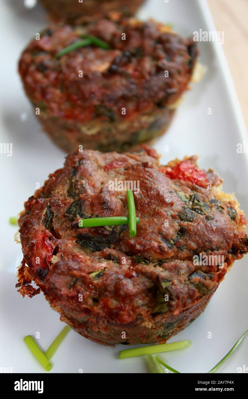Dry breakfast muffins. Muffins with feta cheese and chives. Perfect, tasty breakfast.Muffins with spinach Stock Photo