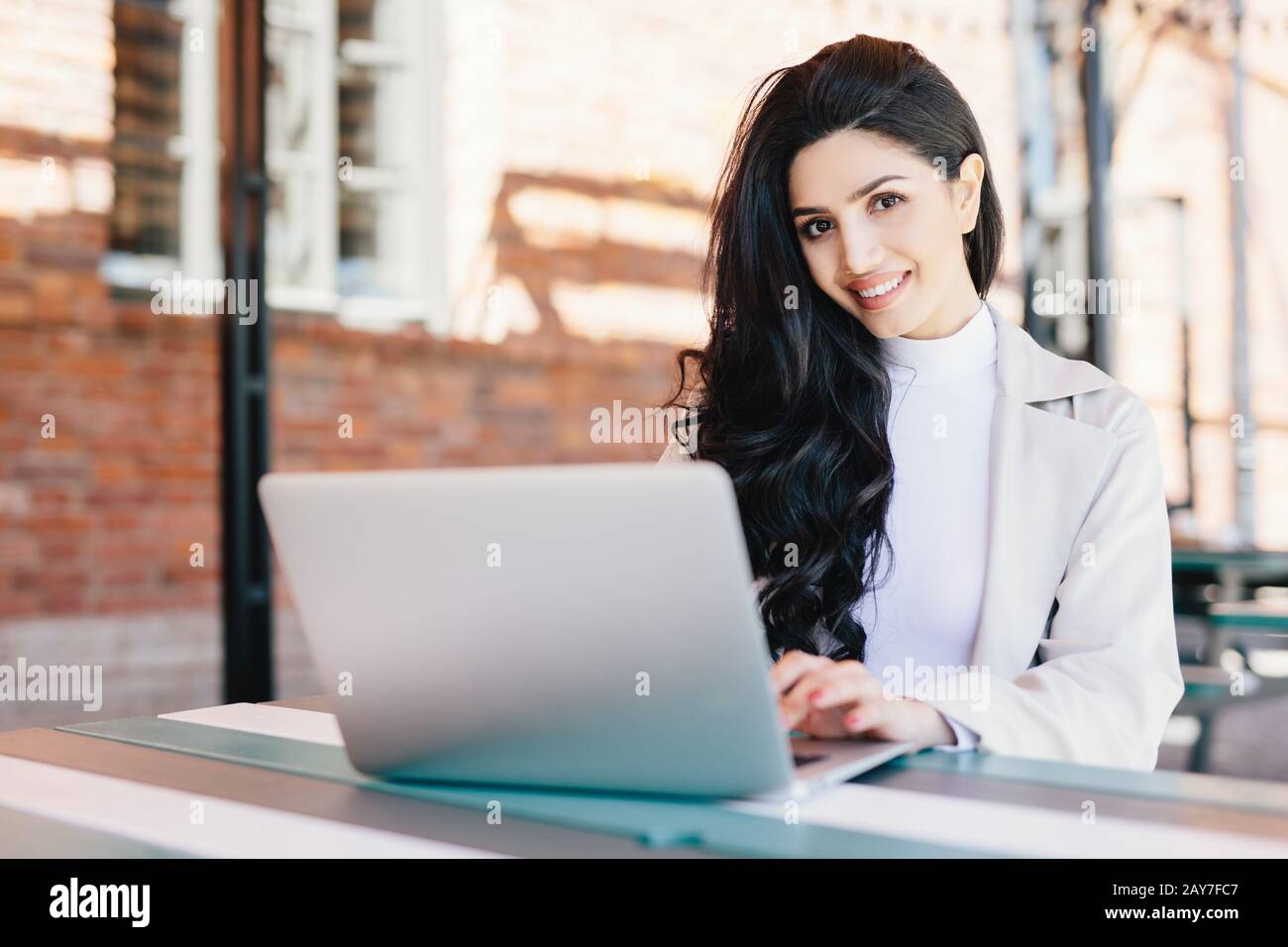 Attractive female blogger typing new challenging post using modern ...