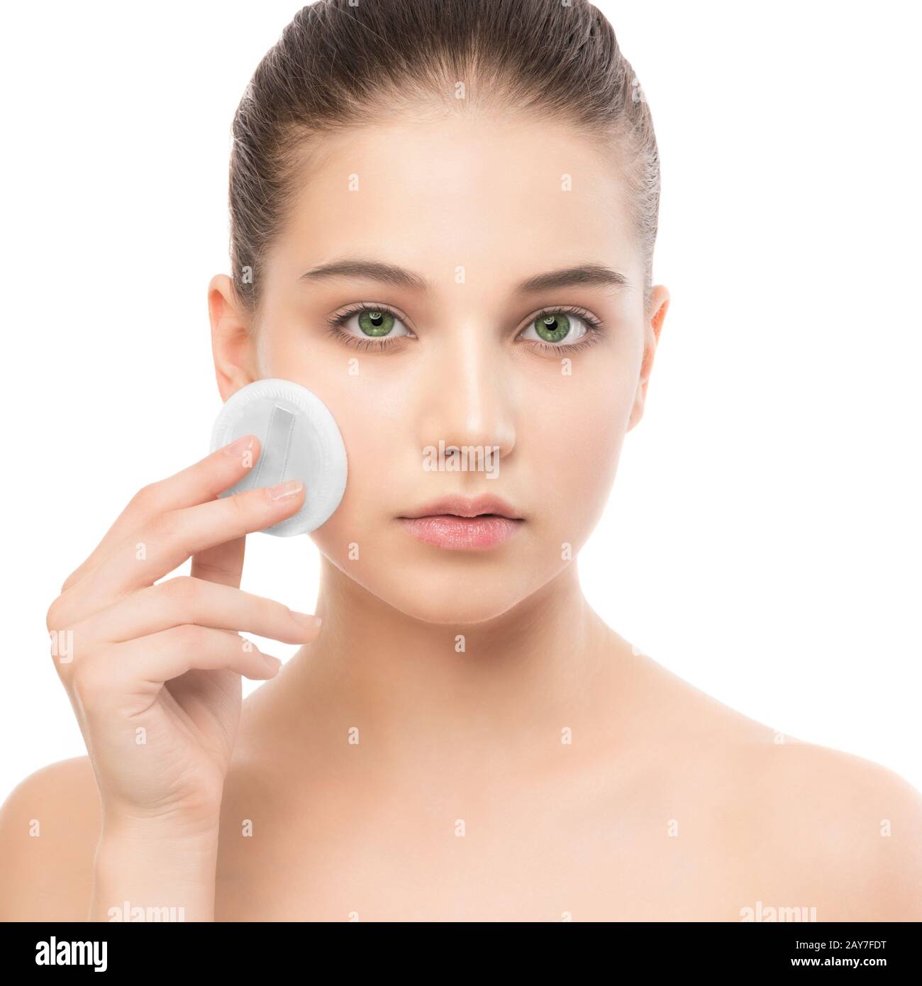 Young woman cares for face skin. Cleaning perfect fresh skin using cotton pad. Isolated. Stock Photo