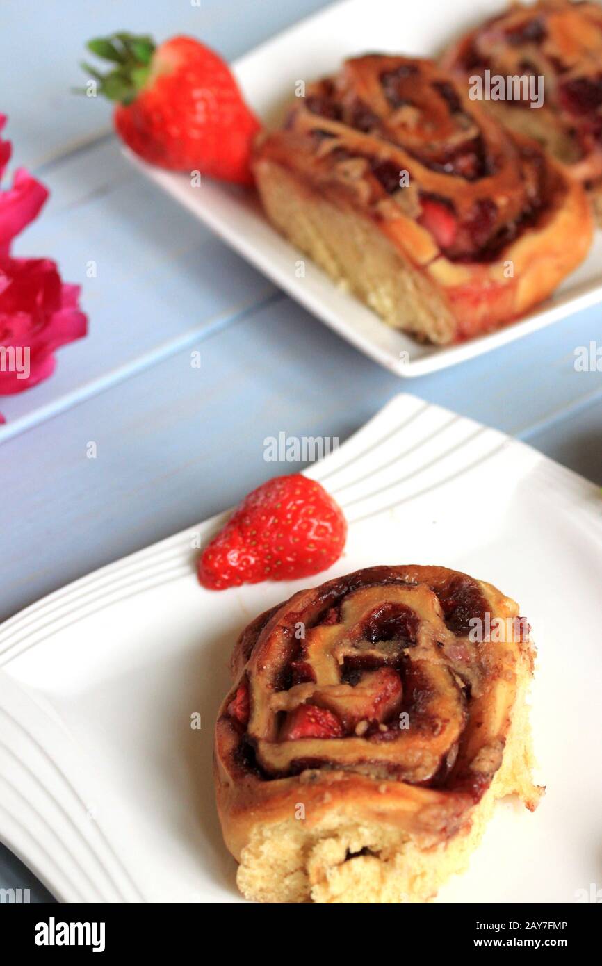 Strawberry buns with cinnamon. Yeast buns with strawberries. Yeast dough. Homemade pastries. A tasty and healthy snack. Stock Photo