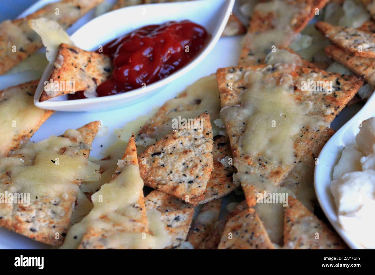 Tortilla Chips. Homemade cheese chips. Nachos. A tasty, home-made and healthy snack. Snack for guests. Stock Photo