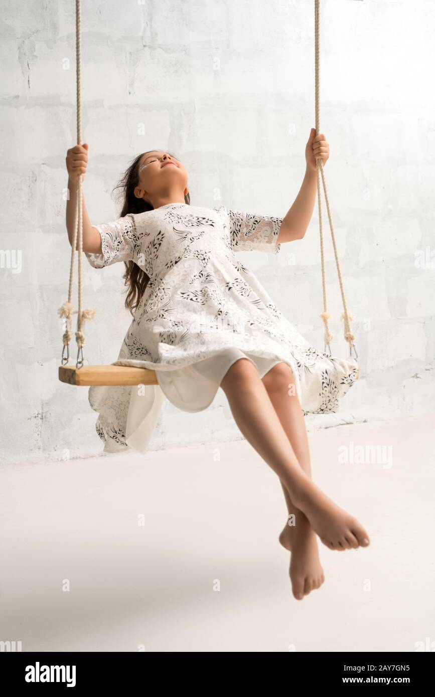 Teenaged pretty brunette swinging sunny shot Stock Photo - Alamy