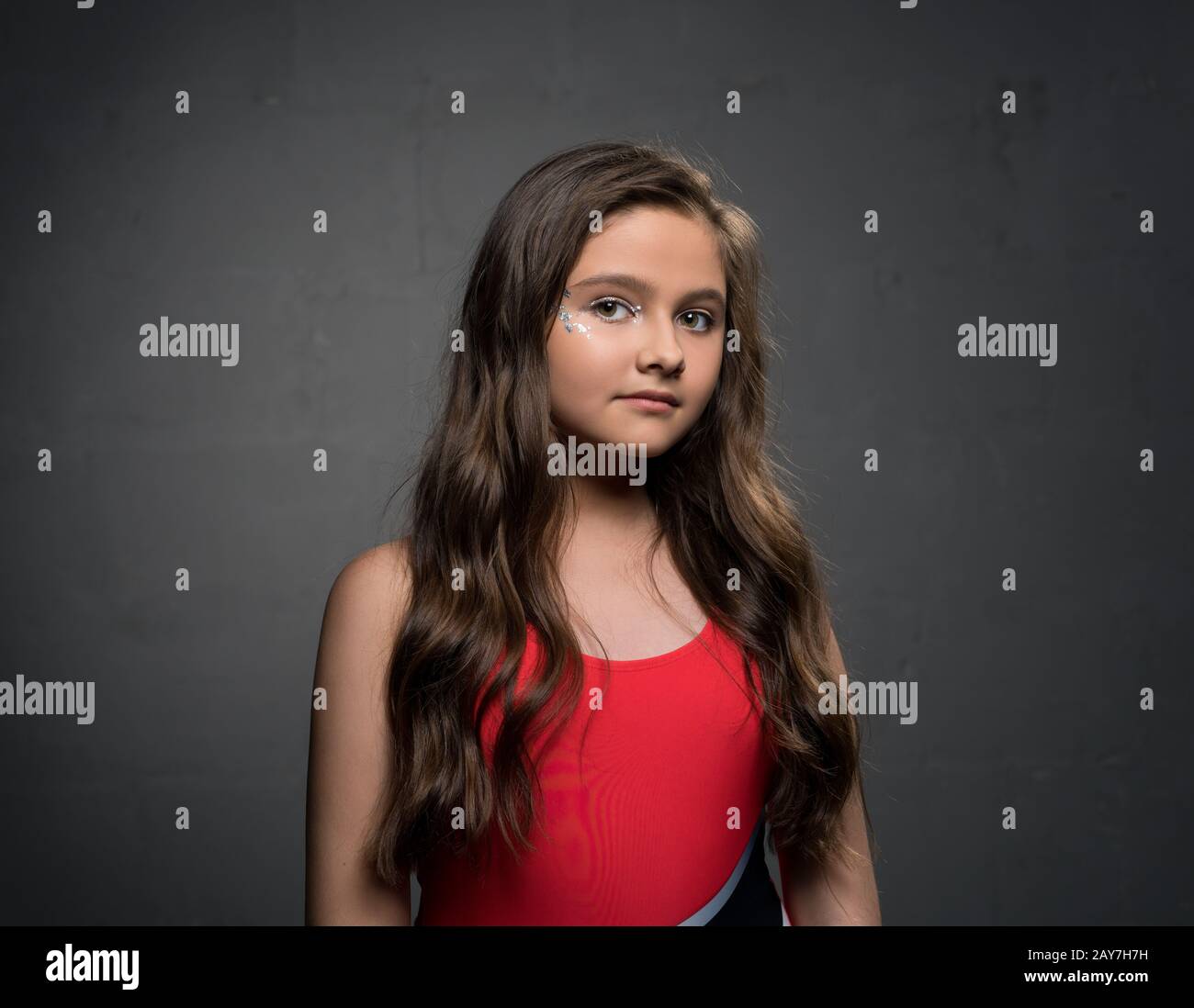 Teenaged pretty brunette against gray background Stock Photo