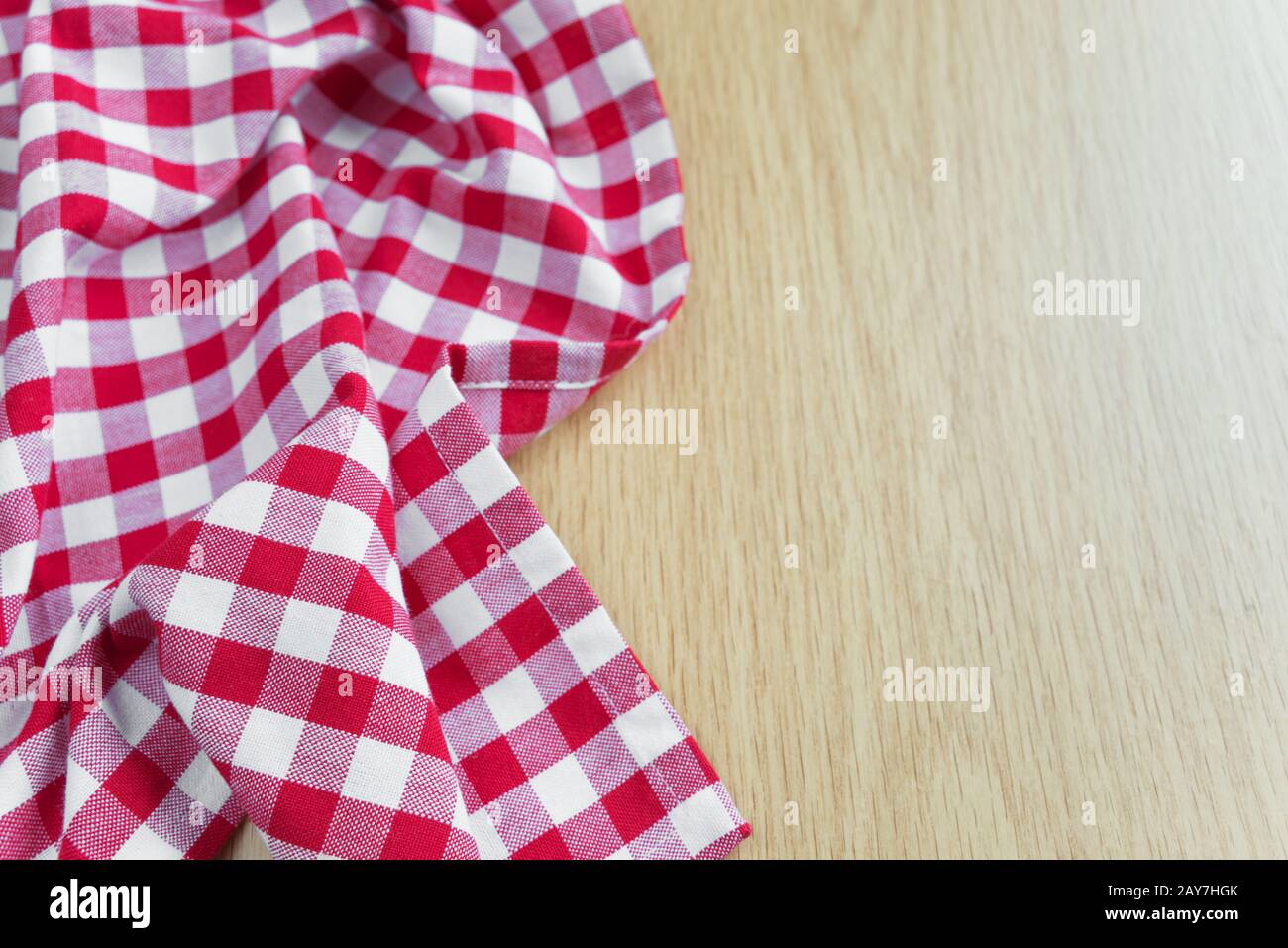 Checked tablecloth is on the wooden table Stock Photo