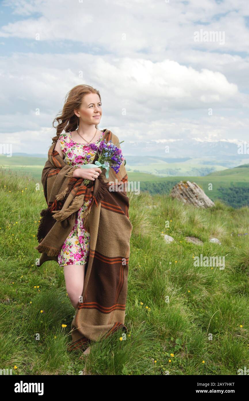 beautiful blonde girl wrapped in a plaid stands with a bouquet of ...