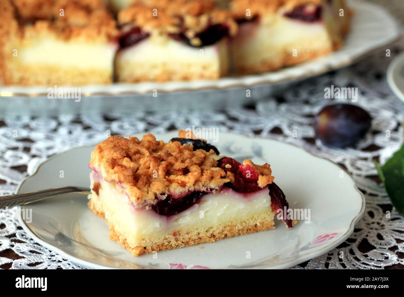 Cake with plums and custard. Homemade cake. Cake with fruit. A delicious and light dessert. Plum cake. Stock Photo