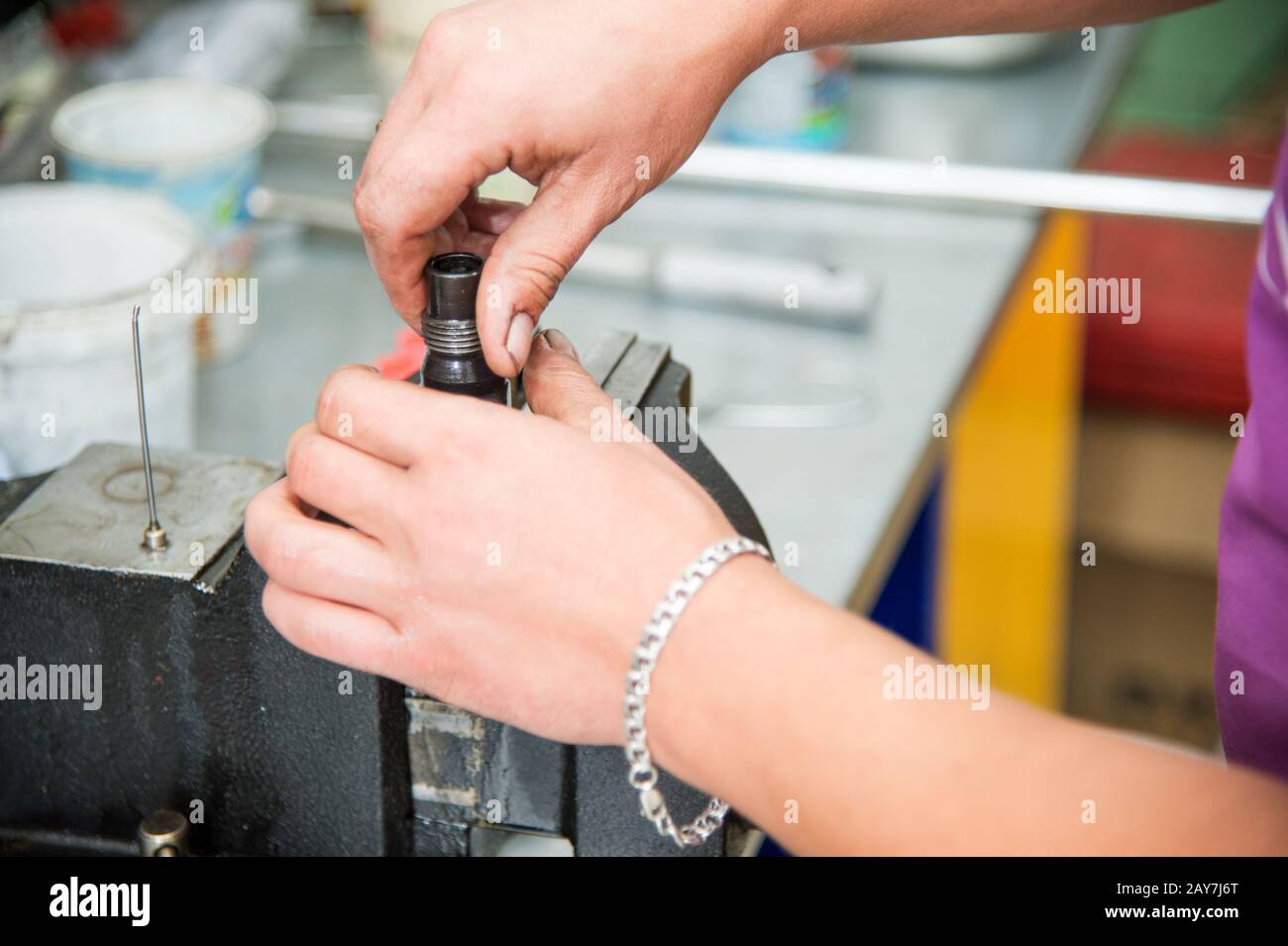 Male hands dismantle a mechanical diesel nozzle to replace the sprayer Stock Photo