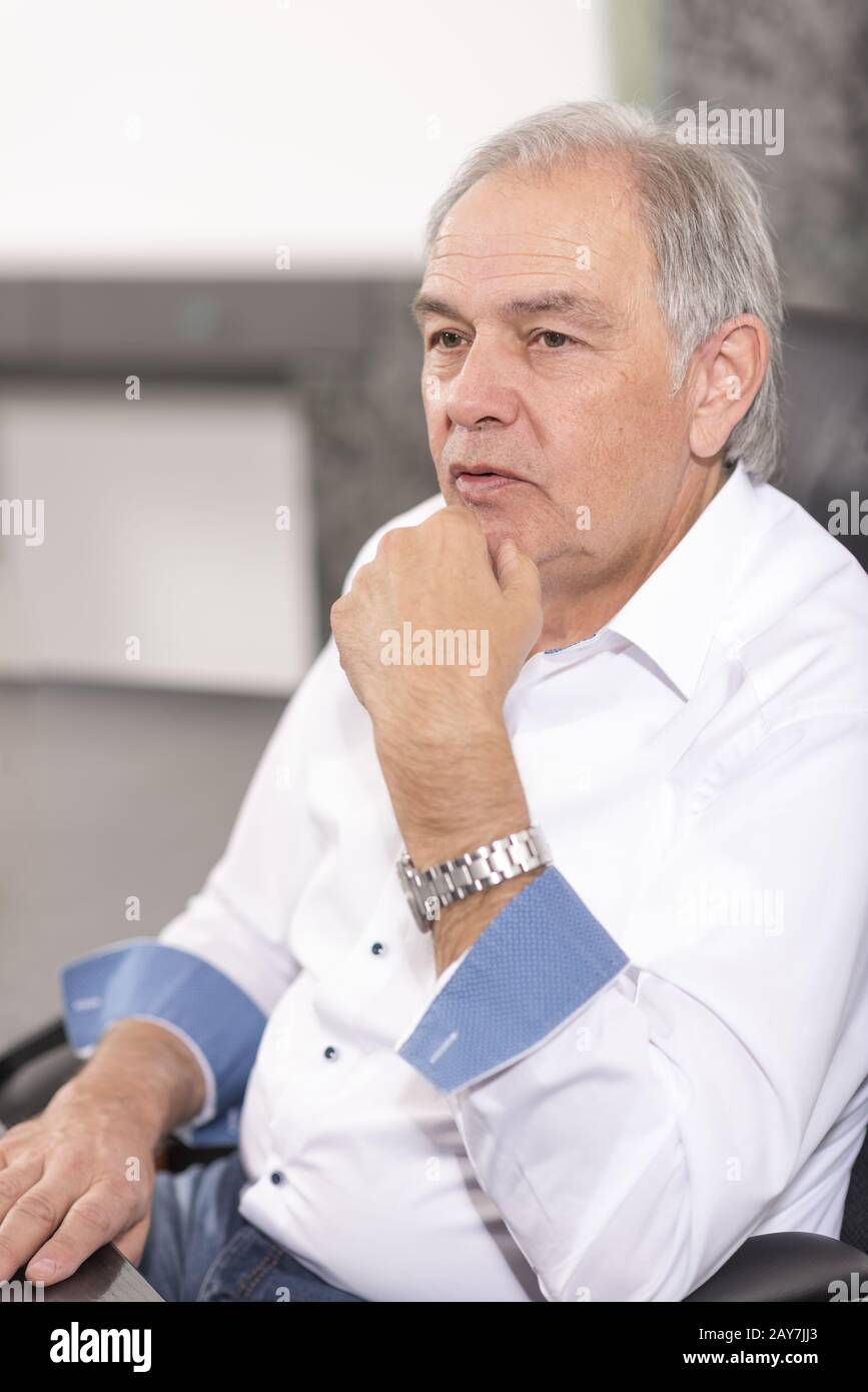 Senior man sitting desk hi-res stock photography and images - Alamy
