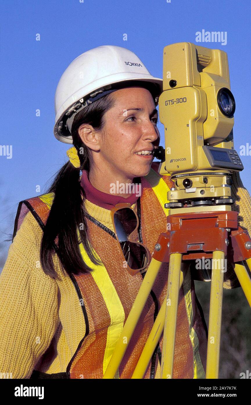 Texas Female surveyor looking at raw land near Austin highway. ©Bob
